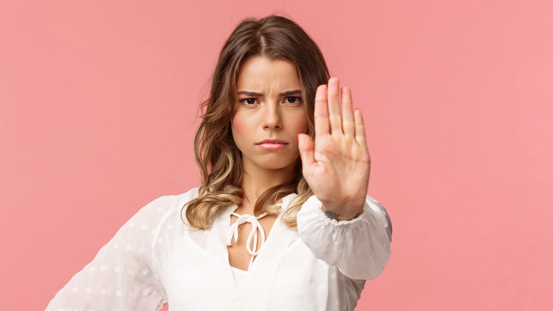 Waist-up portrait of serious-looking assertive and confident young blond female in white dress, extend arm in stop motion, frowning, demand quit, prohibit something, warning express disagreement - Angela's Word - No